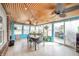 Cozy sunroom featuring tongue and groove ceilings, stylish furnishings, and a sliding glass door at 16371 State Road 38 E, Noblesville, IN 46060