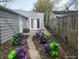 Backyard with double doors, wooden fence, and garden at 1806 Asbury St, Indianapolis, IN 46203