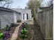 Backyard with double doors, wooden fence, and garden at 1806 Asbury St, Indianapolis, IN 46203