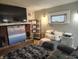 Relaxing basement space with a brick fireplace, mounted TV, and comfortable seating area at 1806 Asbury St, Indianapolis, IN 46203