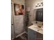 Cozy bathroom features updated vanity, tile, modern fixtures and decor at 1806 Asbury St, Indianapolis, IN 46203