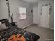 Bright bedroom with a decorative bed, gray walls, and a window with blinds at 1806 Asbury St, Indianapolis, IN 46203