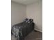 Small bedroom with a single bed and colorful floral pillow at 1806 Asbury St, Indianapolis, IN 46203