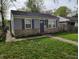 Charming one-story home with stone accents, blue shutters, and a well-maintained lawn at 1806 Asbury St, Indianapolis, IN 46203