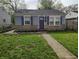 Charming one-story home with stone accents, blue shutters, and a well-maintained lawn at 1806 Asbury St, Indianapolis, IN 46203