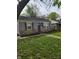 Charming one-story home with stone accents, blue shutters, and a well-maintained lawn at 1806 Asbury St, Indianapolis, IN 46203