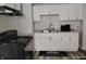 Cozy kitchen featuring white cabinets, dark appliances and gray countertops at 1806 Asbury St, Indianapolis, IN 46203