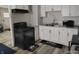 This is a kitchen with white cabinetry, a black stove and a gray speckled countertop at 1806 Asbury St, Indianapolis, IN 46203