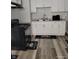 Efficient kitchen featuring white cabinets, modern appliances, and dark accent kitchen rugs at 1806 Asbury St, Indianapolis, IN 46203