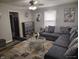 Cozy living room with modern decor, gray sectional sofa, and a glass coffee table at 1806 Asbury St, Indianapolis, IN 46203