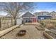 This backyard features a deck, fire pit area, storage shed, and garden beds at 2006 Lexington Ave, Indianapolis, IN 46203