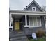 Charming home with gray siding, white trim, and a bright yellow front door at 2006 Lexington Ave, Indianapolis, IN 46203