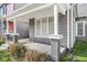Covered front porch with square gray brick columns on a well-maintained gray home at 2006 Lexington Ave, Indianapolis, IN 46203