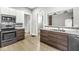The kitchen has stainless appliances, granite countertops and light wood floors at 2006 Lexington Ave, Indianapolis, IN 46203