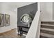 Stylish entryway features a decorative mirror, console table, and staircase with carpeted steps at 2220 Foothill Dr, Greenfield, IN 46140