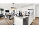 Modern kitchen island with seating overlooks open dining, blending cooking and social spaces beautifully at 2230 Hemlock Cir, Greenfield, IN 46140