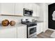 Modern kitchen includes stainless steel appliances, sleek white cabinets, and quartz countertops at 2230 Hemlock Cir, Greenfield, IN 46140