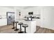 Bright kitchen boasts an island with bar seating, white cabinets, and stainless steel appliances at 2230 Hemlock Cir, Greenfield, IN 46140