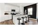 Bright kitchen features a quartz island, white cabinetry, stainless steel appliances, and black accent wall at 2230 Hemlock Cir, Greenfield, IN 46140