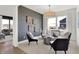 Modern living room features accent wall, stylish seating, overhead light fixture, and opening to another living space at 2230 Hemlock Cir, Greenfield, IN 46140
