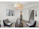 Modern living room features artwork, stylish seating, overhead light fixture, and staircase to the second floor at 2230 Hemlock Cir, Greenfield, IN 46140