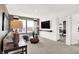 Bright living room with a sectional sofa, large windows, stylish lamps, and mounted television at 2230 Hemlock Cir, Greenfield, IN 46140
