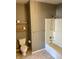 Neutral bathroom featuring toilet, tub/shower combo, and floating shelves at 2250 N Pennsylvania St # 8, Indianapolis, IN 46205