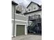 Two-story home with gray wood siding, a dark gray deck with stairs, and a matching garage at 2250 N Pennsylvania St # 8, Indianapolis, IN 46205