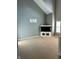 Spacious living room with vaulted ceiling, media center, and sun-drenched windows at 2250 N Pennsylvania St # 8, Indianapolis, IN 46205