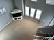 Open concept living room featuring vaulted ceiling, large windows, and neutral carpet at 2250 N Pennsylvania St # 8, Indianapolis, IN 46205