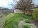 Spacious backyard featuring a wooden swing set, storage shed, lush greenery and a well-maintained lawn, perfect for outdoor enjoyment at 265 Bittersweet Dr, Whiteland, IN 46184