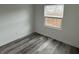 This bedroom features hardwood floors and a window for natural light at 265 Bittersweet Dr, Whiteland, IN 46184