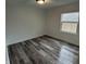 This bedroom features hardwood floors and a window for natural light at 265 Bittersweet Dr, Whiteland, IN 46184