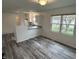 A bright dining area adjacent to a modern kitchen and offers outdoor views through a window at 265 Bittersweet Dr, Whiteland, IN 46184