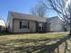 Cozy ranch-style house with beige siding, dark shutters, and a well-maintained lawn under a clear, sunny sky at 265 Bittersweet Dr, Whiteland, IN 46184