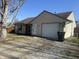 Charming single-story home with an attached garage, complemented by a green lawn and a clear, sunny sky at 265 Bittersweet Dr, Whiteland, IN 46184