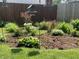Charming backyard garden bed featuring colorful flowers and lush greenery, adding a touch of natural beauty to the landscape at 265 Bittersweet Dr, Whiteland, IN 46184