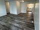 Spacious living room with vinyl flooring and white walls, showcasing an open floor plan into the adjacent kitchen at 265 Bittersweet Dr, Whiteland, IN 46184