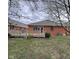 Cozy backyard with a wooden deck, brick exterior, and mature landscaping features at 2856 Colony Lake East Dr, Plainfield, IN 46168