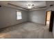 Large primary bedroom features a decorative ceiling trim, carpeted floors and a window with blinds at 2856 Colony Lake East Dr, Plainfield, IN 46168
