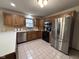 Well-lit kitchen with wooden cabinets, stainless steel appliances, and tile backsplash at 2856 Colony Lake East Dr, Plainfield, IN 46168