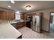 Fully equipped kitchen with wooden cabinetry, stainless steel appliances, and a tile backsplash at 2856 Colony Lake East Dr, Plainfield, IN 46168