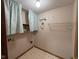 Functional laundry room area with shelving and stylish curtains, perfect for organization and storage at 2856 Colony Lake East Dr, Plainfield, IN 46168