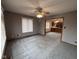The living room features a ceiling fan, window with blinds, and neutral gray carpet and paint at 2856 Colony Lake East Dr, Plainfield, IN 46168
