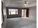 Bright living room with large windows, ceiling fan, and neutral gray walls with a view to the front entrance at 2856 Colony Lake East Dr, Plainfield, IN 46168