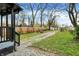 Spacious backyard with a grass lawn, wooden fence, and a gravel driveway at 2915 E 19Th St, Indianapolis, IN 46218