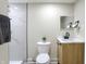 Bathroom featuring a shower with marble-look tile, toilet, and vanity with a wood-look cabinet at 2915 E 19Th St, Indianapolis, IN 46218