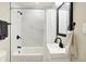 Bathroom featuring a shower-tub combination with white marble-look tile and black hardware at 2915 E 19Th St, Indianapolis, IN 46218