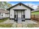 Charming home with fresh white siding, black trim, and a covered front porch at 2915 E 19Th St, Indianapolis, IN 46218
