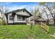 Street view of a charming house with black and white trim and a grassy lawn leading up to the house at 2915 E 19Th St, Indianapolis, IN 46218